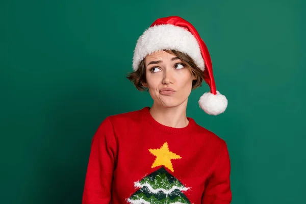 Photo of minded lady look interested empty space hesitate contemplate isolated on green color background.