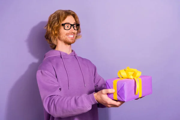 Side view of confident young Asian male with Afro hairstyle in yellow  sweatshirt looking at camera against white wall with shadow in sunlight  Stock Photo - Alamy