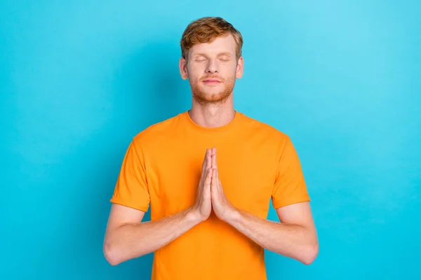 Photo of rest ginger hair guy close eyes wear orange t-shirt isolated on teal color background.