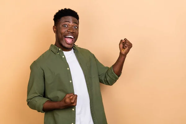 stock image Photo of hooray millennial brunet guy yell wear khaki shirt isolated on beige color background.