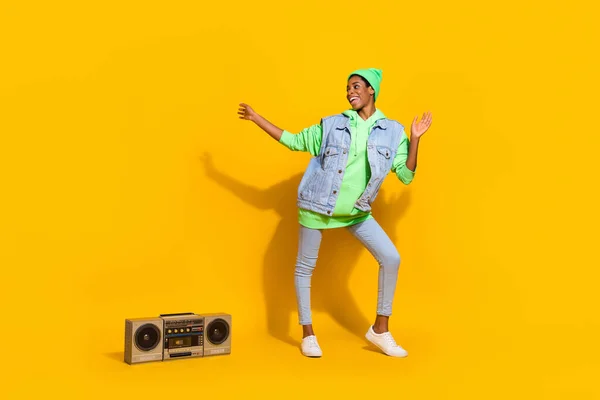 Full size portrait of energetic cheerful person enjoy pastime dj boom box isolated on yellow color background.