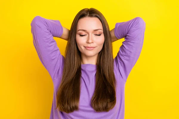 Photo of calm charming pretty woman wear purple pullover closed eyes hands behind head take nap chill isolated on bright yellow color background.
