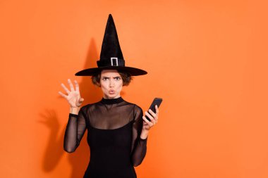 Photo of attractive terrifying lady hold telephone arm make scary boo gesture isolated on orange color background. clipart