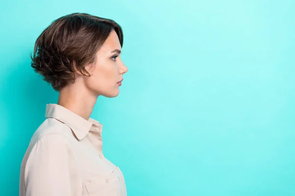 Side profile photo of young bob brown hair businesswoman looking empty space advertisement offer isolated on aquamarine color background.