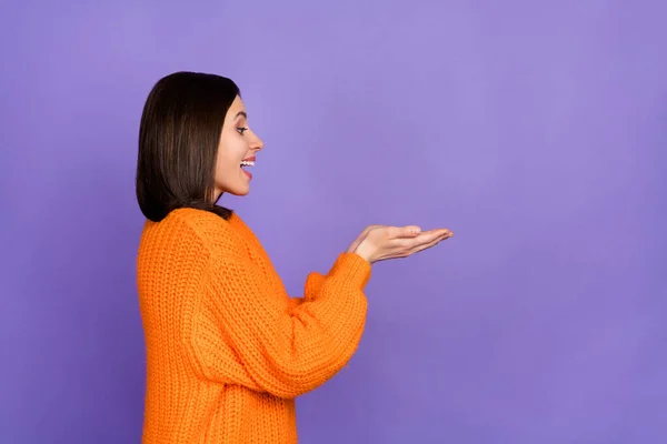 Profile photo of cheerful charming person look arms hold empty space isolated on violet color background.