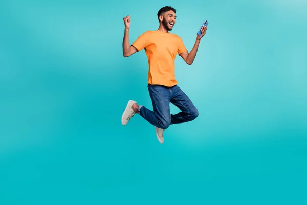 Full Length Photo Positive Lucky Guy Wear Orange Shirt Jumping — Zdjęcie stockowe