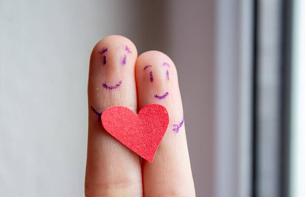 Smiley faces drawn on fingers. Happy couple hugging. Valentine's day background photo.