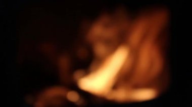 Blurry flames. Woods burning in the darkness.