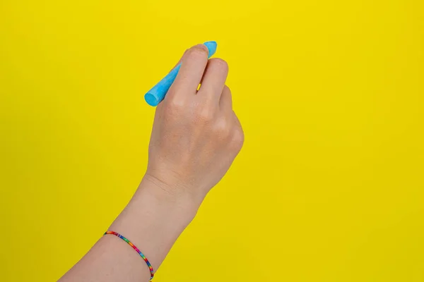 Hand Holding Chalk Isolated Yellow Background Woman Writing Something Blue — Stock Photo, Image