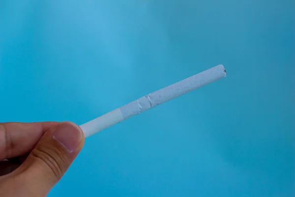 Hand Holding Cigarette Blue Background — Stock Photo, Image