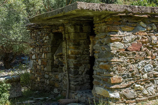 Old stone house. Abandoned house made of mud brick wall in the forest.