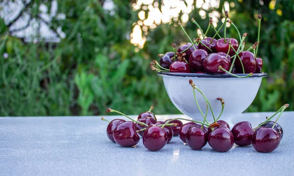 Cherries on wooden table. Cherry fruits in bowl with space for text.