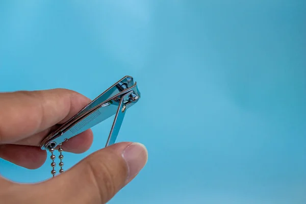 Hand Holding Nail Scissors Isolated Blue Background — Stock Photo, Image