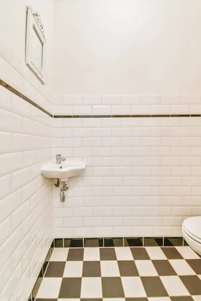 Small restroom with checkerboard floor — Stock Photo, Image