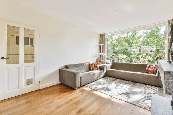 Large gray sofa in a cozy living area — Stock Photo, Image