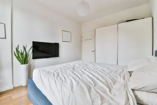 Znakomita sypialnia z niebieskim łóżkiem i pokryte miękką narzutą — Zdjęcie stockowe