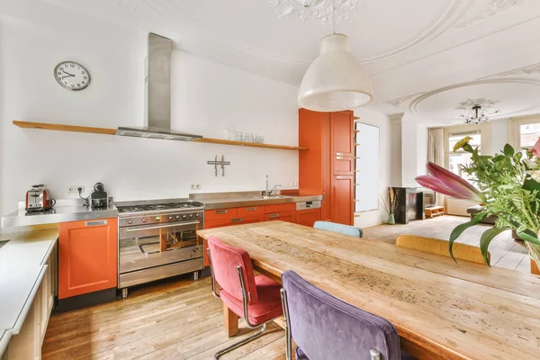 Stunning dining room with a wooden table and an unusual chandelier — Zdjęcie stockowe