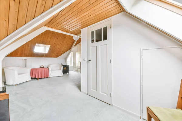 Cozy furnished attic with a high wooden ceiling — Stok fotoğraf