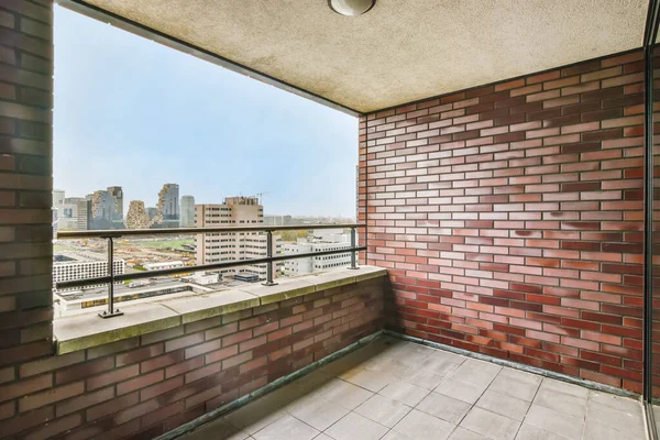 Stylish balcony with brick walls — Stockfoto