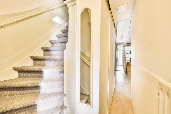 Nice staircase with gray carpet and white walls — Stok fotoğraf