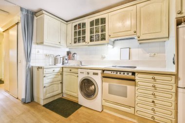 Nice kitchen in light colors with a washing machine