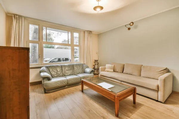 Nice living room with beige sofa — стоковое фото
