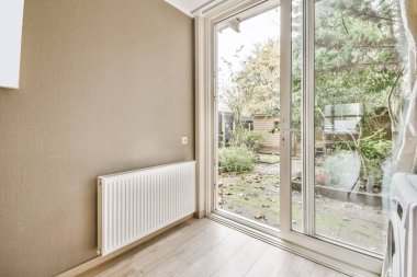Nice room with an open door near the radiator