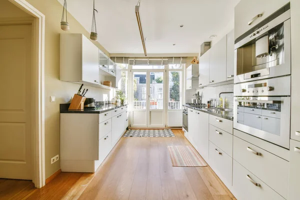 Luxurious kitchen area with parquet flooring
