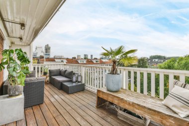 Luxurious balcony with gray sofa