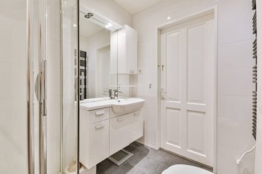 Büyük lavabosu ve aynası olan göz kamaştırıcı şık bir banyo.