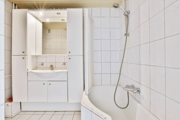 Современная ванная комната с белой плиткой стен и пола — стоковое фото