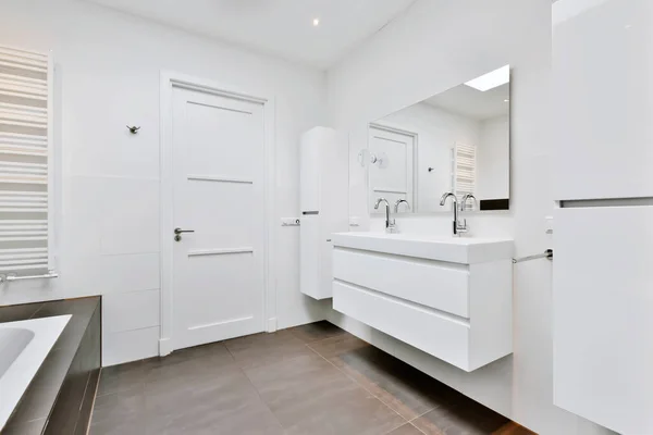 The bathroom is in a minimalist style with a white chest of drawers — Stock Photo, Image