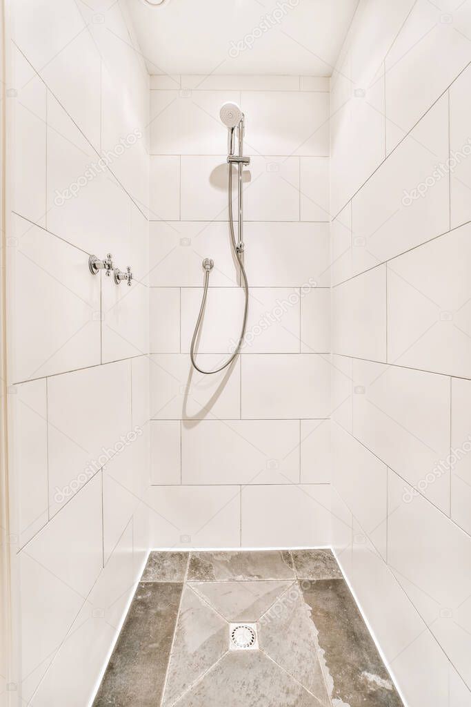 Lovely design of the shower cabin with white tiles