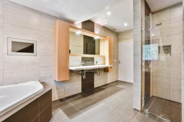Büyük küveti olan rahat bir banyo.