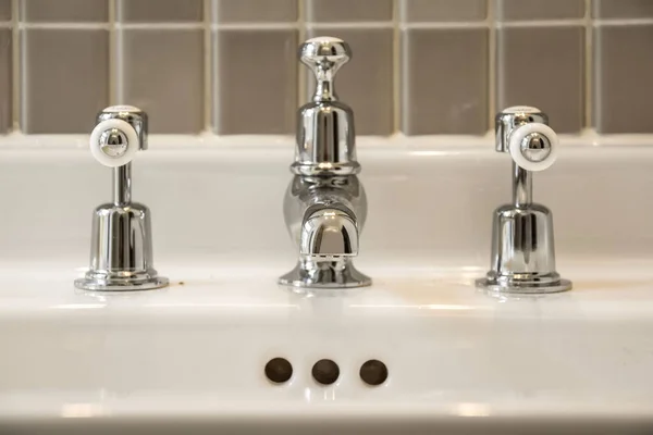 General view of metal valves and a sink faucet — Stock Photo, Image
