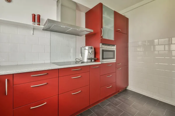 Small kitchen with red furniture Stock Image