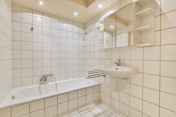 Bright bathroom with white tiles — Stock Photo, Image