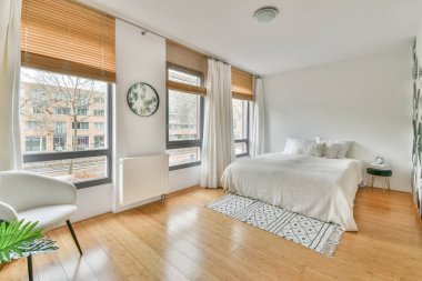 Geniş beyaz yataklı geniş bir yatak odası.