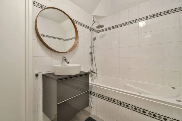 Bathroom interior with white tiles and a pattern on it — ストック写真