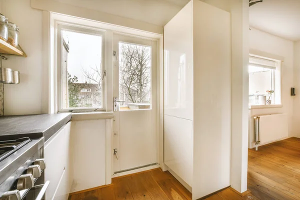 Access to the balcony of a cozy house from a modern kitchen