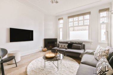 Geniş, parlak oturma odası ve iki küçük kanepesi var.