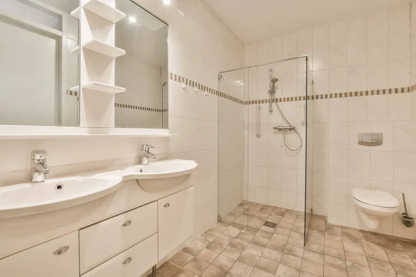 Bathroom interior with white and beige tiles — стоковое фото