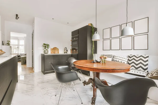 A spacious kitchen in black combined with a dining area — Photo