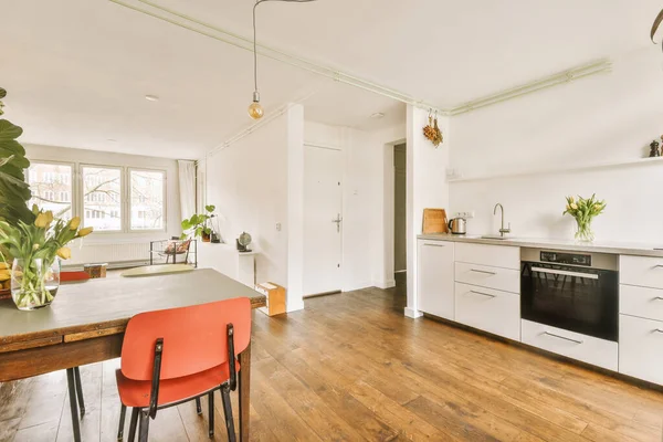 Kitchen and dining room with plants in modern apartment — ストック写真