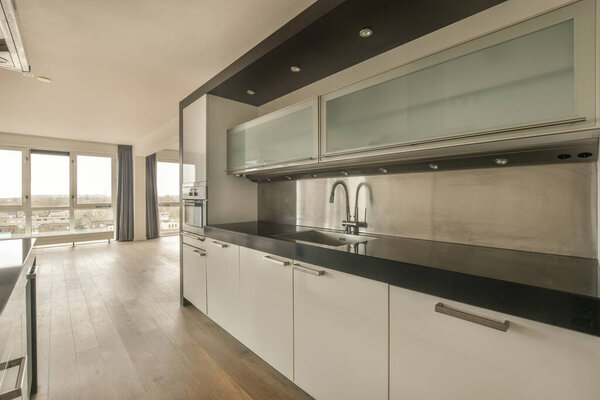 Open-style kitchen with white furniture