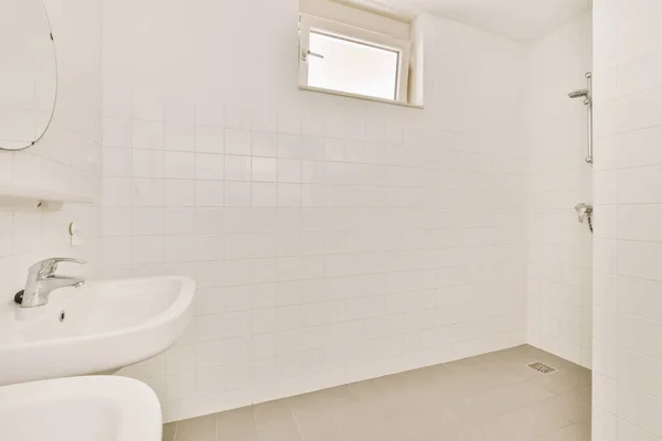 Interior of a bathroom with white tiles — ストック写真