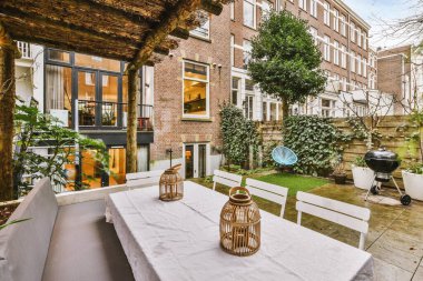 General view of the backyard with tiled floor and a dining area