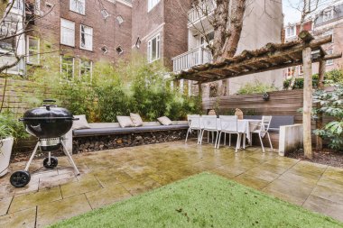 General view of the backyard with tiled floor and a dining area