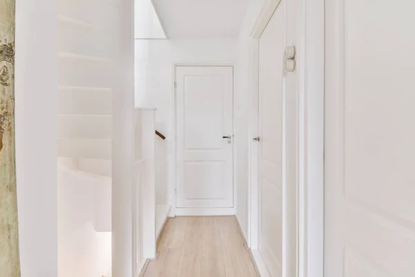 Light narrow hallway with staircase and doors — Stockfoto