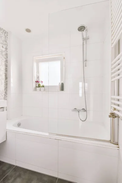 Bathtub with shower near small window — 스톡 사진